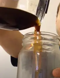 Adding brewed coffee in the mason jar