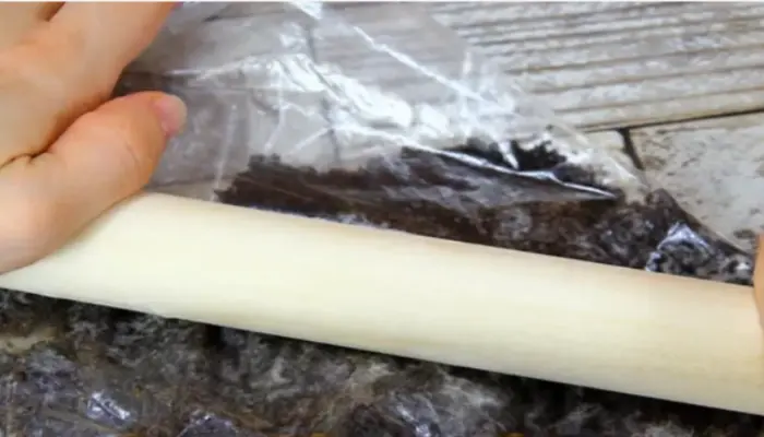 Crushing-cookies-in-a-plastic-bag-with-roller