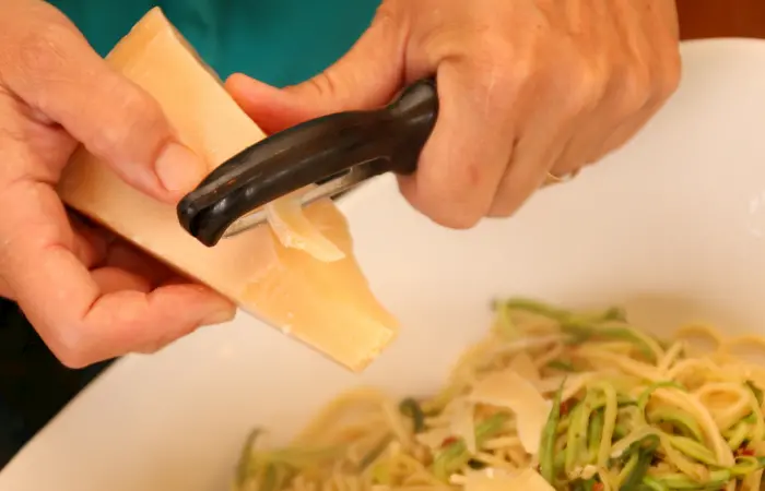 Grating cheese with vegetable peeler