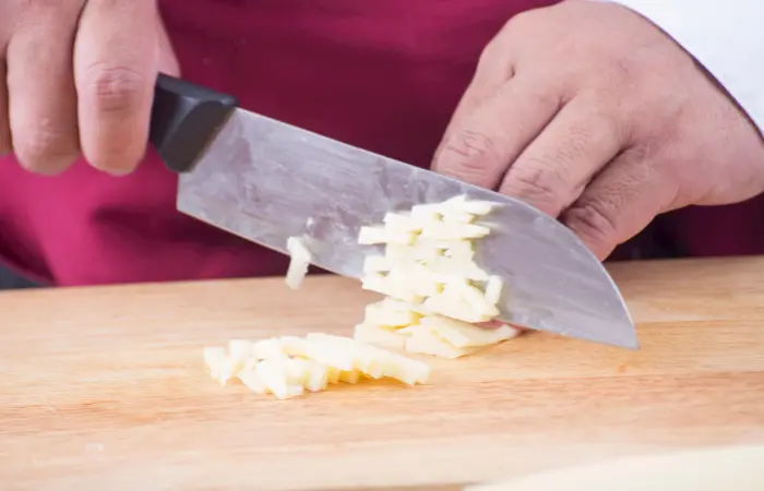 Cutting cheese with knife
