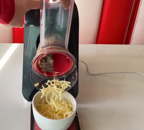 Grating cheese using an electric grater