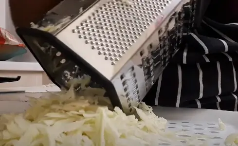 Using box grater for shredding cabbage