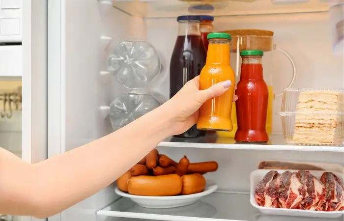 Putting orange juice in the fridge