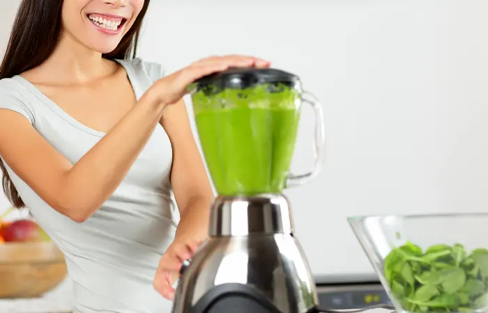 Blending leafy green into a smoothie